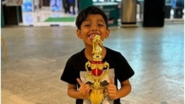 A young student celebrating a chess achievement after a competitive tournament.