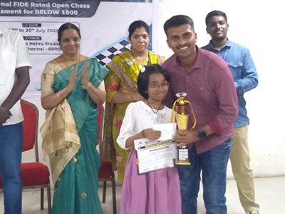 Avighna Shakthi receiving an award for achievement in a competitive chess tournament.