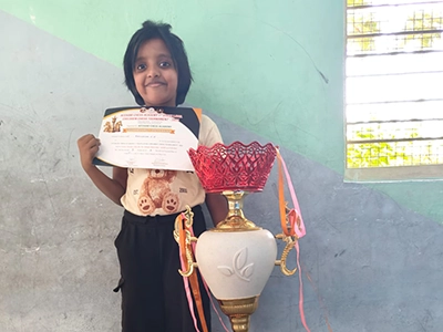 Pavishna receiving third prize recognition at a chess tournament for excellent play.