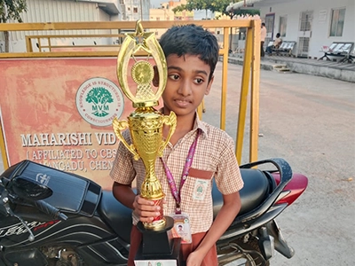 Rejolin honored with a chess award for strong performance in a competitive event.