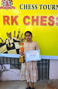 A Time2Chess student receiving recognition for strong performance in a chess competition.