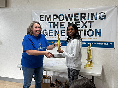 Sadhana showcasing her chess winner trophy after excelling in a competitive tournament.